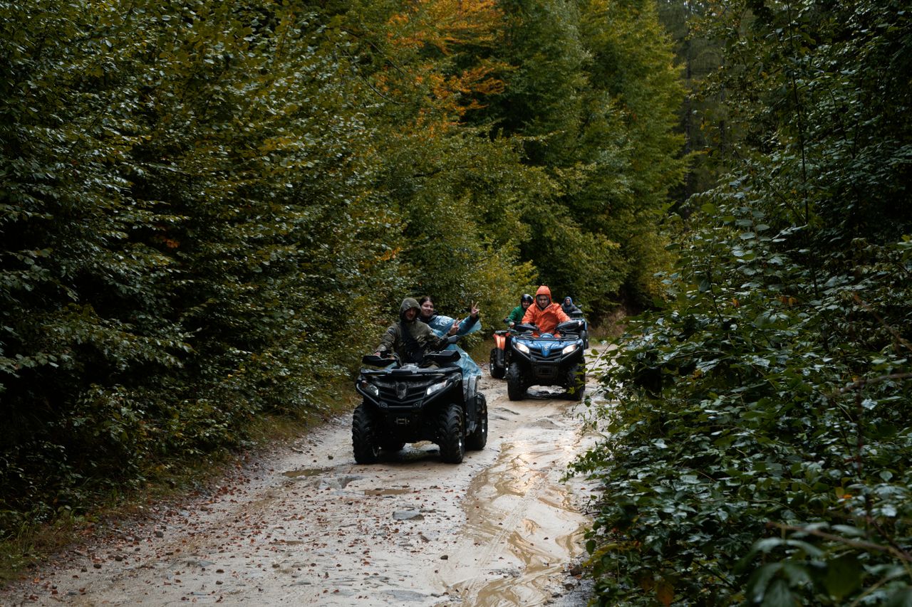 Group enjoying an adventurous ATV ride through a lush forest trail, exploring nature.